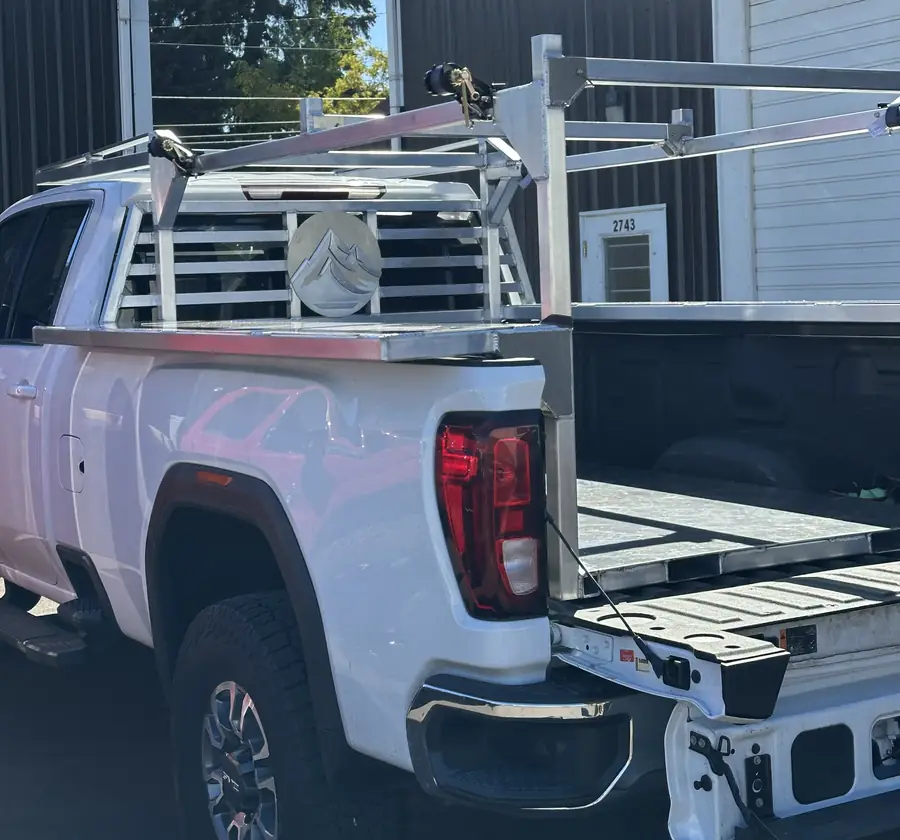 Custom aluminum ladder rack and headache rack on a white pickup