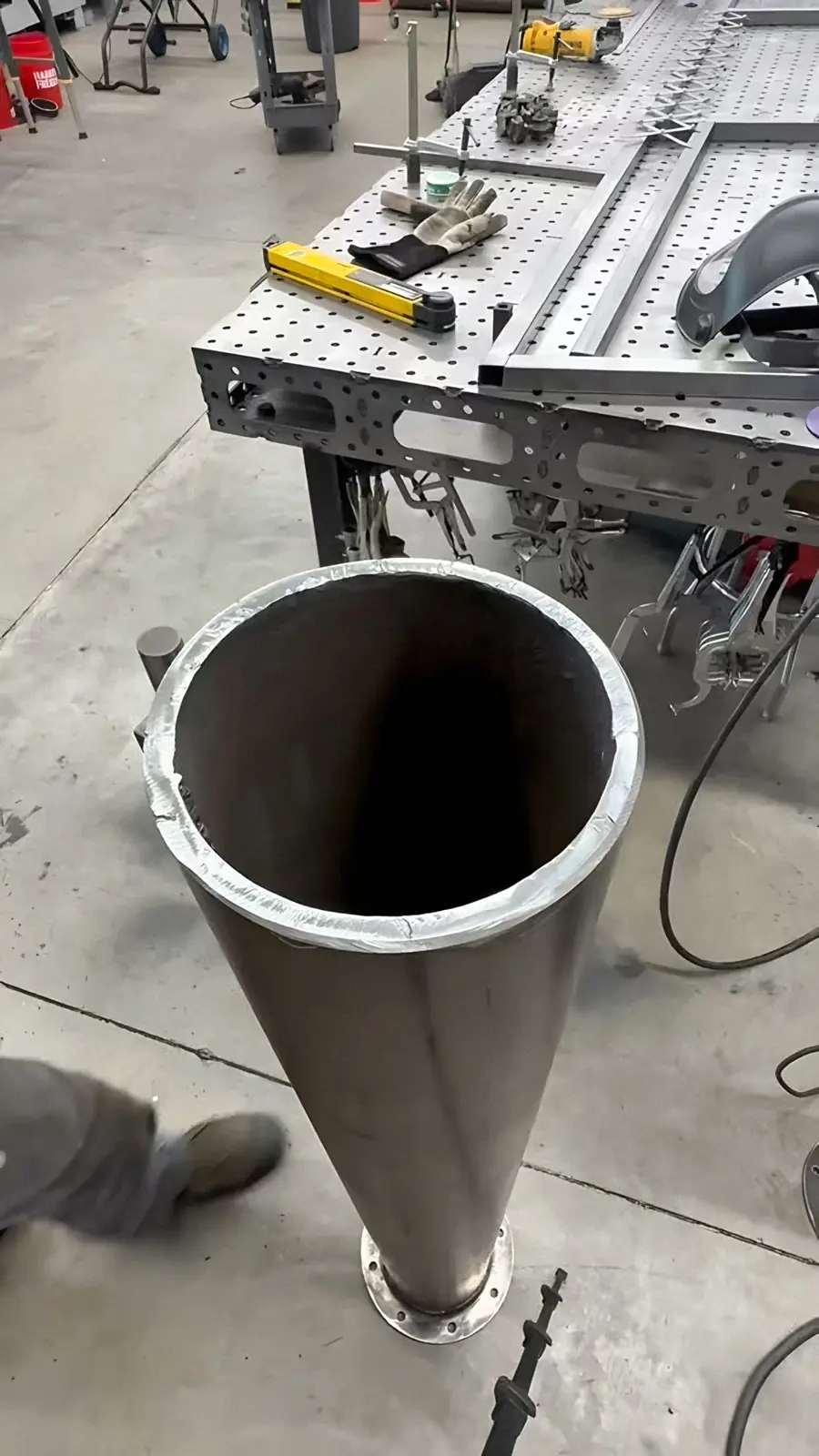 Tube section standing by the weld table in Neal's shop