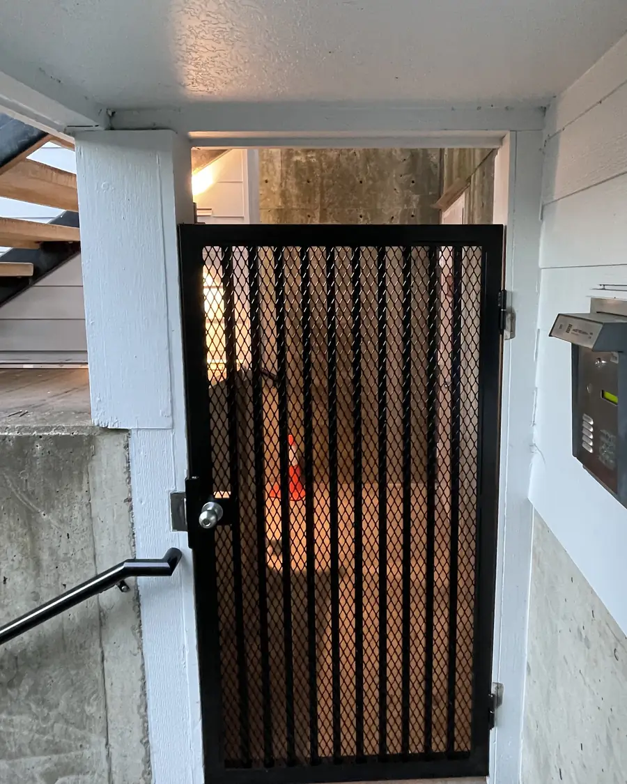 New black steel security gate with expanded mesh at the same apartment entry