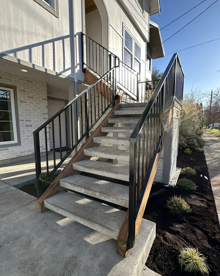 The same stairs with black steel railings on both sides