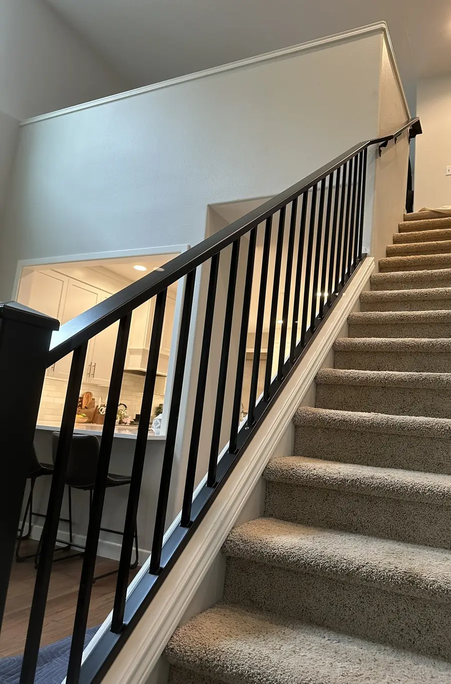 Black steel stair railing inside a house