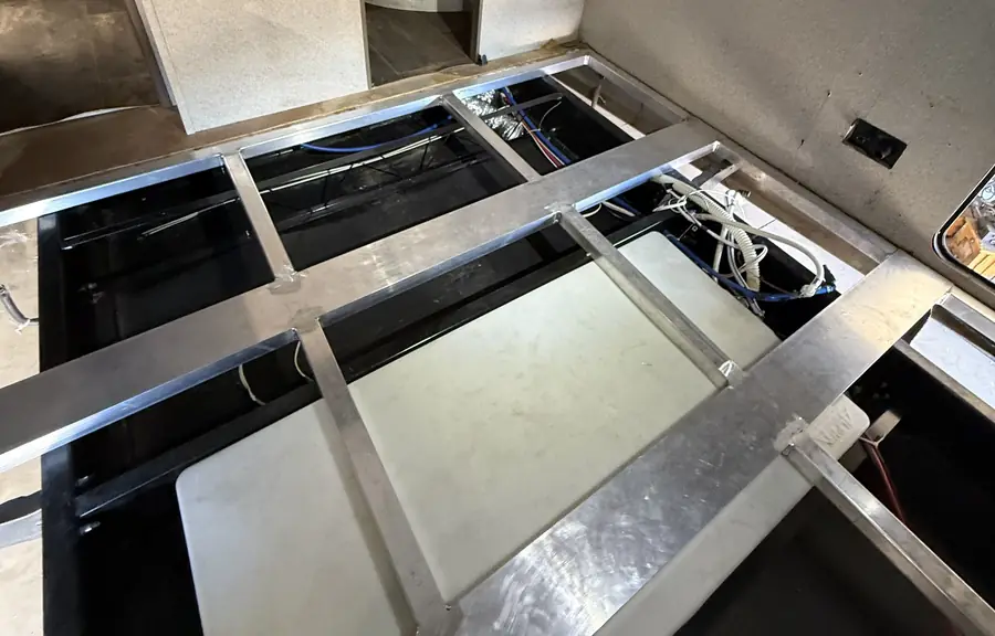 New aluminum floor grid welded into an RV, the old floor out